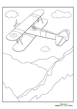 Biplane flying over the mountains